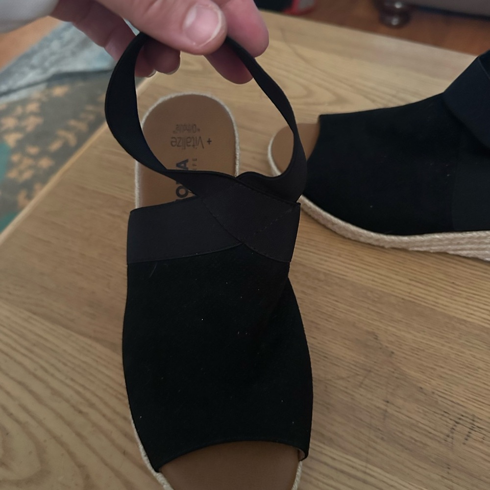 Black woman’s wedge sores with ankle strap